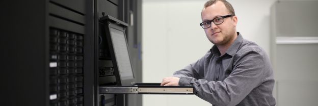 Man Sitting Facing the Camera With a Tech Device